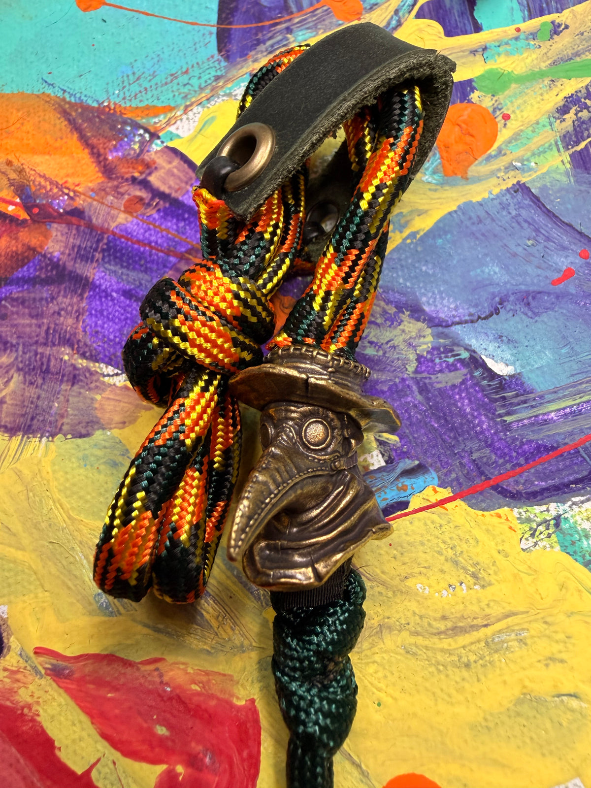 Orange Yellow & Black Paracord EDC - Frameless Slingshot w/ Plague Doctor Charm - Green Leather