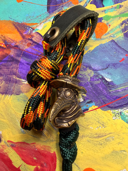 Orange Yellow & Black Paracord EDC - Frameless Slingshot w/ Plague Doctor Charm - Green Leather