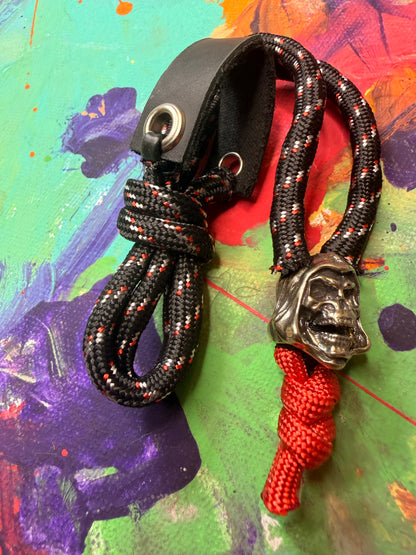 Black & Red Paracord EDC - Frameless Slingshot w/ Skeletor Charm- Black Leather