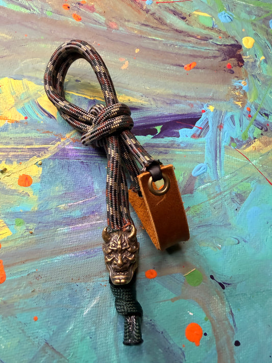 Dark Camo Paracord EDC - Frameless Slingshot w/ Horned Mask Charm - Genuine Leather