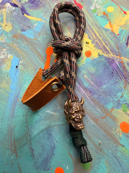 Dark Camo Paracord EDC - Frameless Slingshot w/ Horned Mask Charm - Genuine Leather